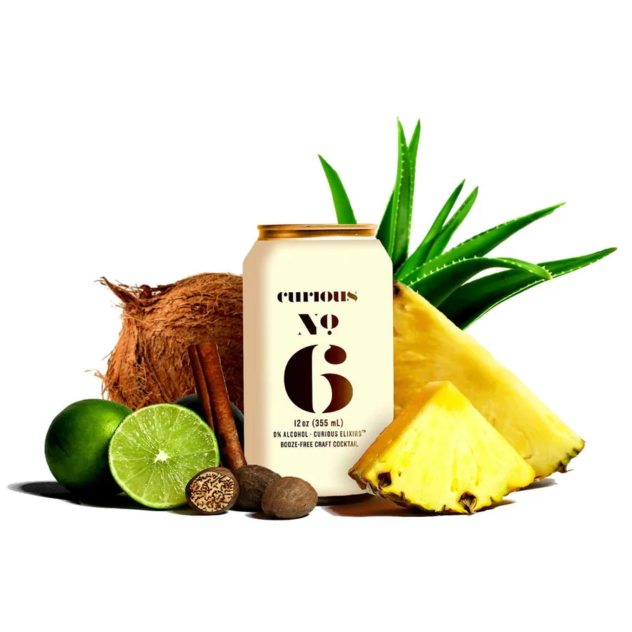 Curious No. 6, a non-alcoholic Spiced Coconut Pineapple, in a can beside fresh coconut, pineapple, and lime.