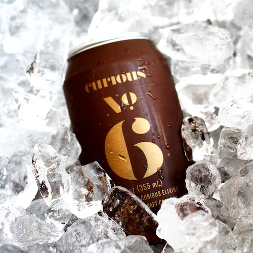 Curious Elixirs branded can on ice
